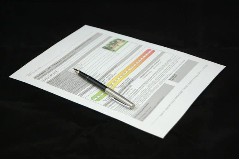 Pen on paper document, dark background.