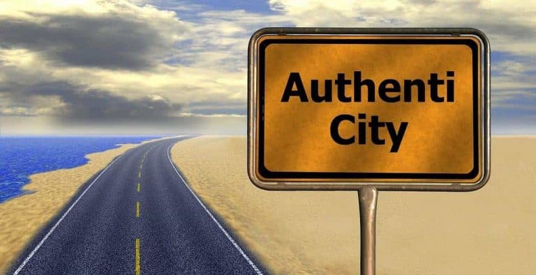 Road sign saying Authenti City by seaside