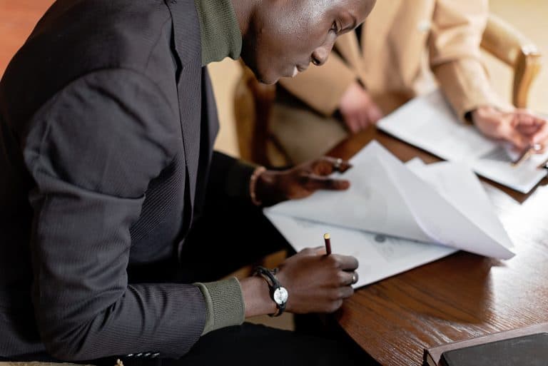Man signing documents at a table