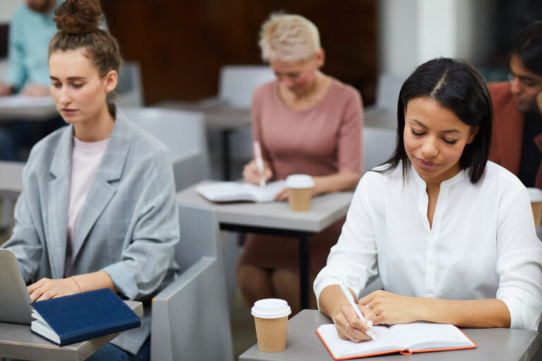 Students writing in classroom setting