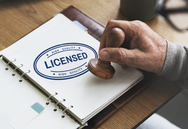 Licensed stamp on document with hand-held stamper.