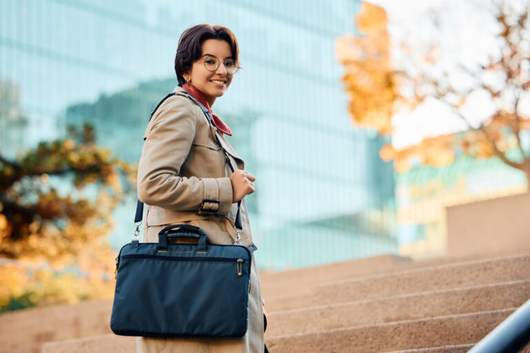 Person with bag on stairs outside building