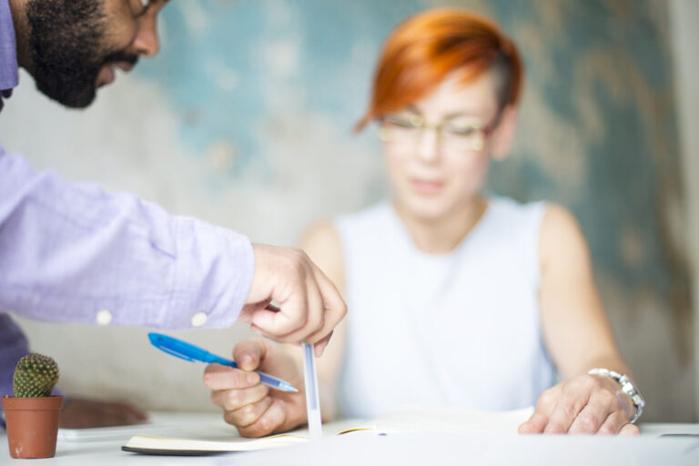 People collaborating on a project at a table.